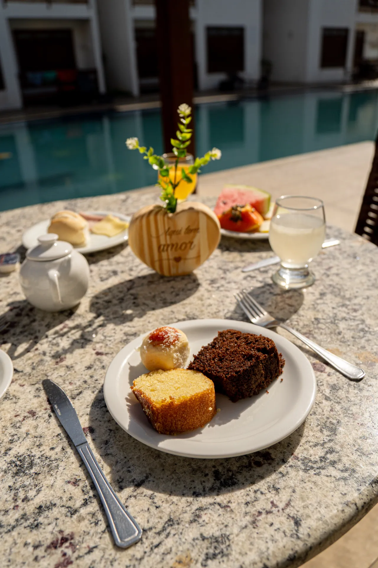 Breakfast with homemade cakes and pool view at Hotel Encantos de Itaperapua