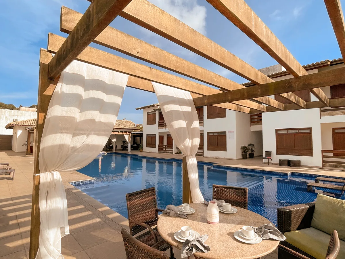 Breakfast served under the pergola, by the pool at Hotel Encantos